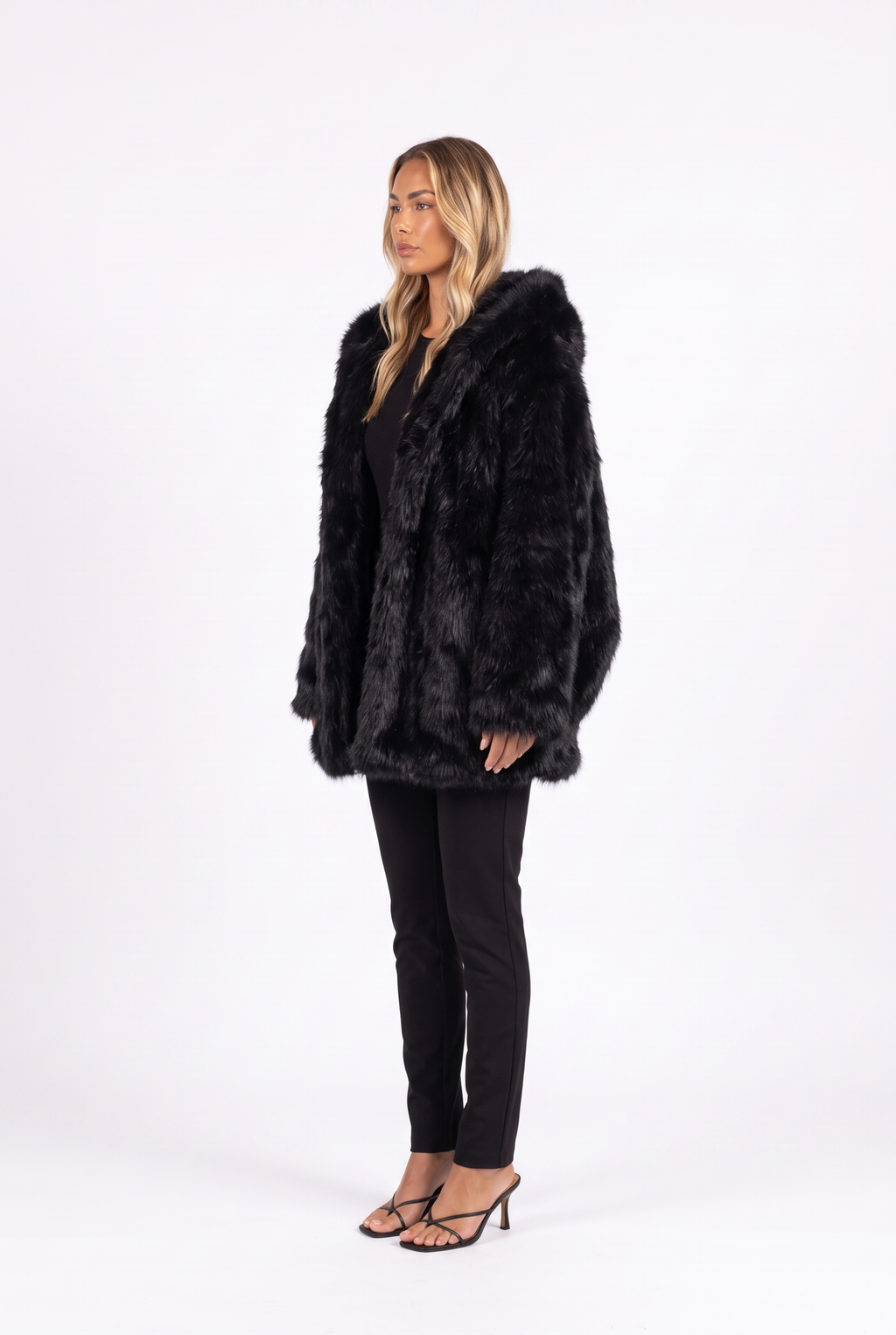 Oversized shaggy faux fur hooded coat in black — side