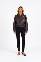 Brown faux-leather cropped belted moto jacket — front