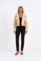 Metallic gold faux-leather cropped moto jacket with faux shearling trim — front