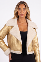 Metallic gold faux-leather cropped moto jacket with faux shearling trim — shearling collar and cuff detail