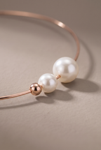 Close-up of the metal ball and two pearls on the wire end