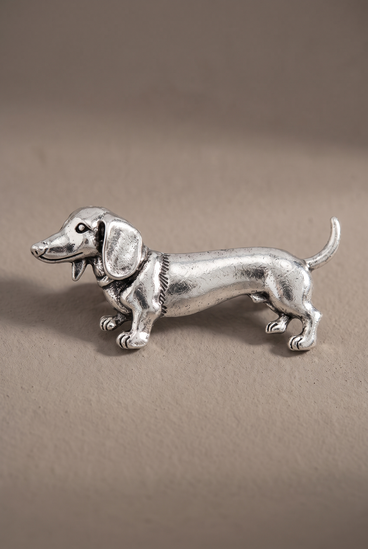 Close-up of the sculpted dachshund brooch