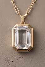 Close-up of the emerald-cut crystal in its gold-tone bezel
