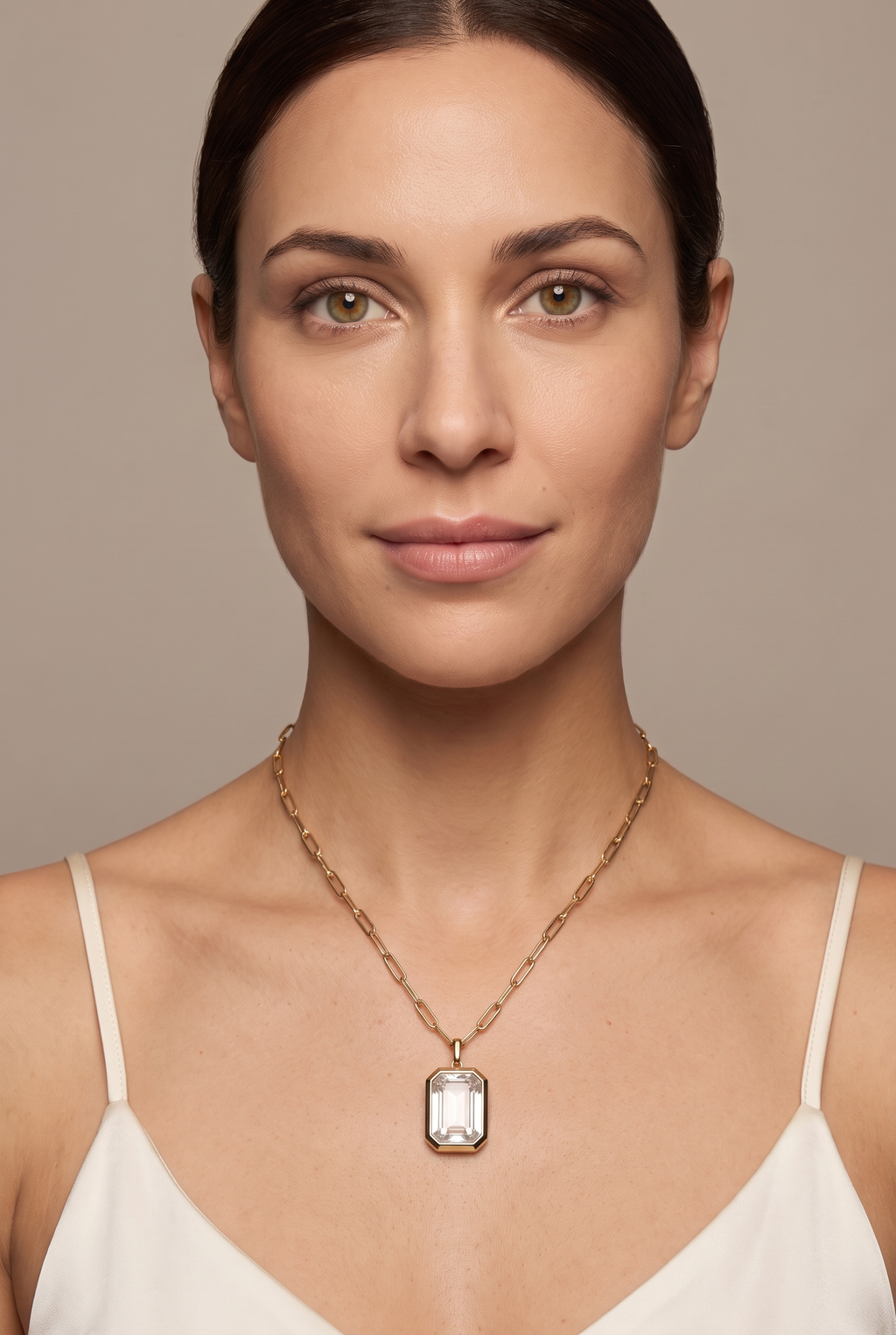 Clear crystal bezel pendant necklace worn at the collarbone