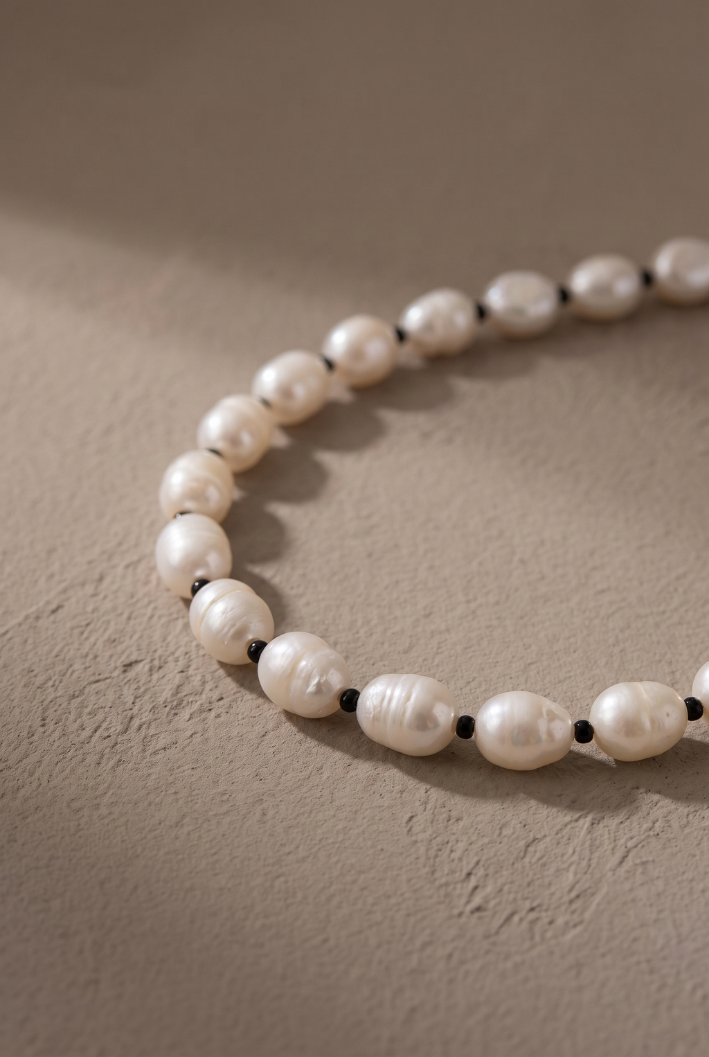 Close-up of the 8-9 mm baroque pearls and tiny black spacers