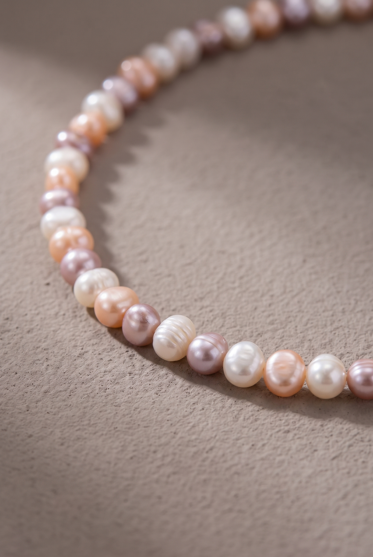 Close-up of the white, peach and lilac nugget pearls